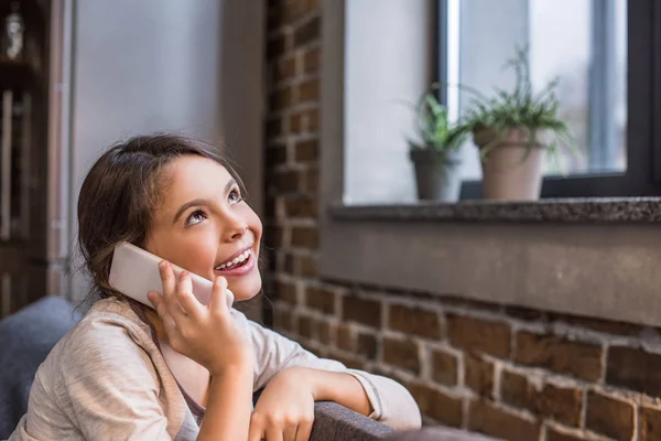 Kid talking on smartphone at home — Stock Photo, Image