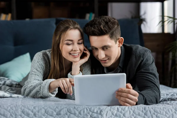 Glückliches Paar Liegt Und Schaut Auf Tablet — Stockfoto