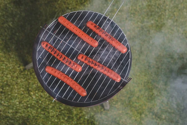 Hot dog sausages on grill — Stock Photo
