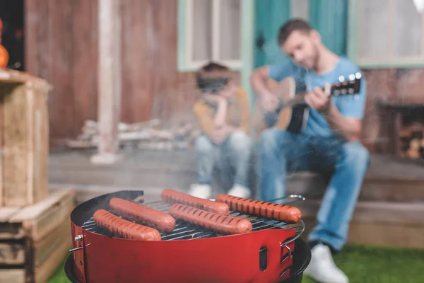 Hot dog sausages on grill — Stock Photo