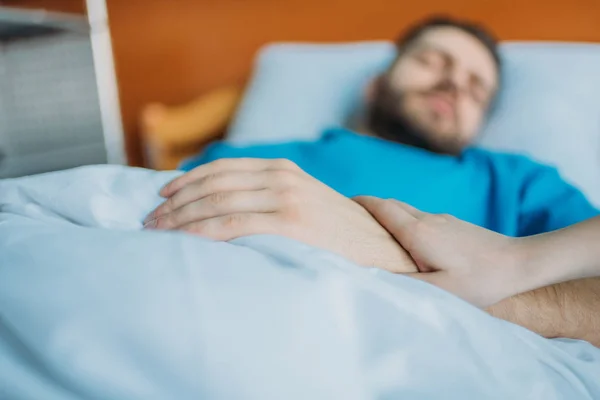 Father at ward holding hands with son — Stock Photo