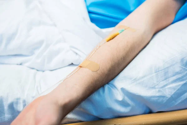 Mann liegt mit Klapptisch im Bett — Stockfoto