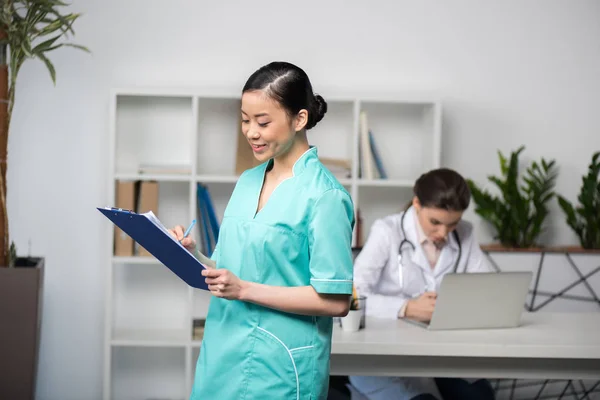 Internista segurando prancheta com diagnóstico — Fotografia de Stock