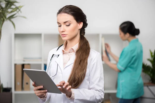 Doctor using digital tablet — Stock Photo