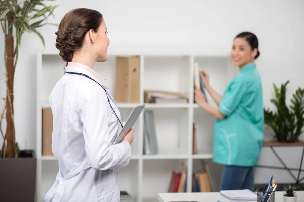 Doctor using digital tablet — Stock Photo