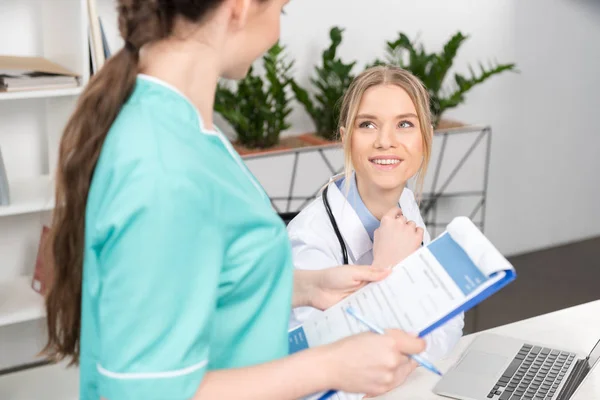 Smiling doctor and nurse — Stock Photo