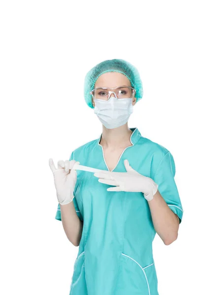 Young surgeon taking off medical gloves — Stock Photo