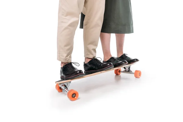 Casual couple riding on skateboard — Stock Photo