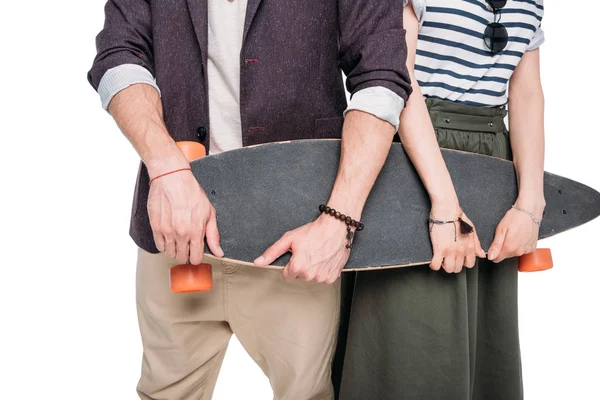Casual couple holding skateboard — Stock Photo