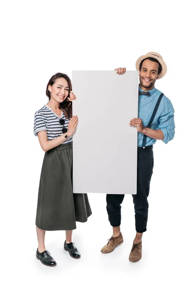 Multiethnic friends holding empty banner — Stock Photo