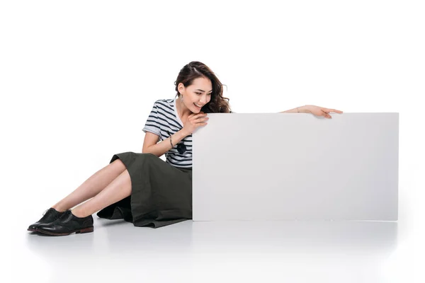 Woman sitting and holding blank board — Stock Photo