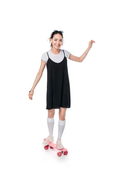 Casual asian girl riding on skateboard — Stock Photo