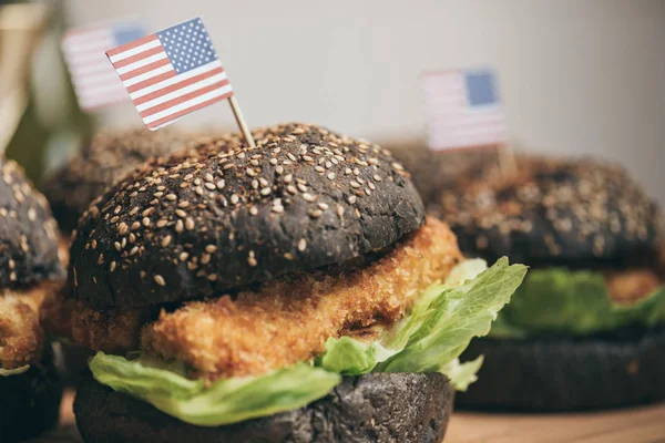 Tasty burgers with american flags — Stock Photo