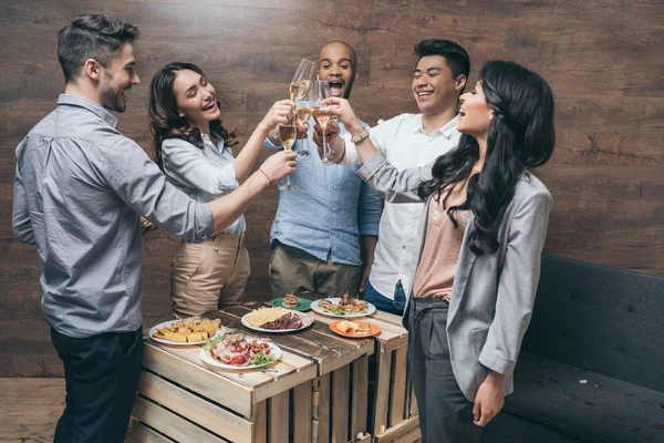 Young people celebrating with champagne — Stock Photo