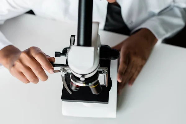 Scientist with microscope in lab — Stock Photo