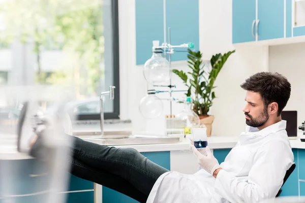 Scientist holding flask — Stock Photo