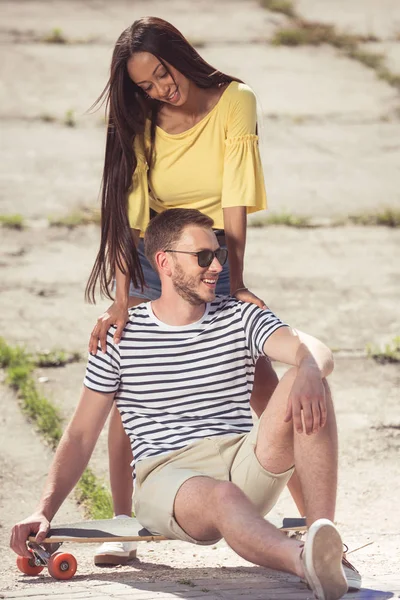 Multiethnic couple with skateboard — Stock Photo