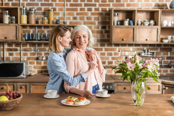 Women having good time in kitchen — Stock Photo