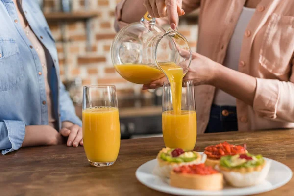 Women drinking orange juice — Stock Photo
