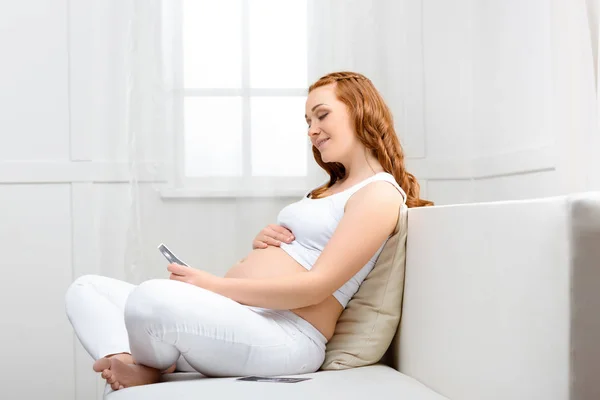 Pregnant woman with ultrasound scan — Stock Photo