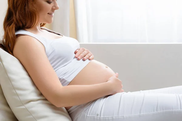 Pregnant woman touching her belly — Stock Photo