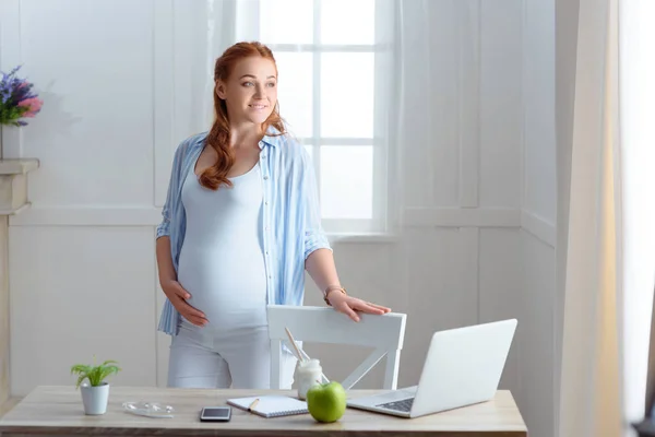 Redhead pregnant woman at home — Stock Photo