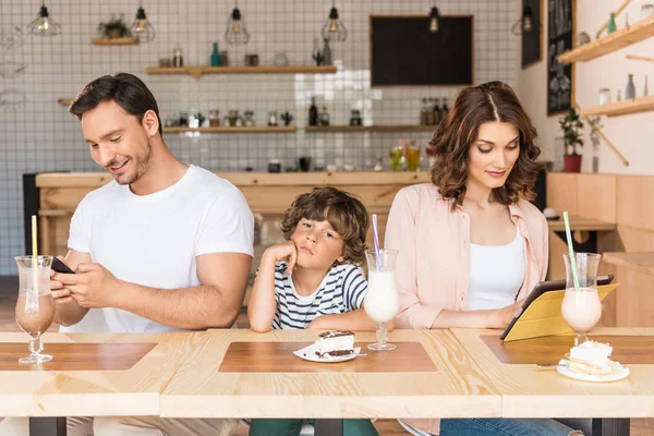Parents using gadgets while their son bored — Stock Photo