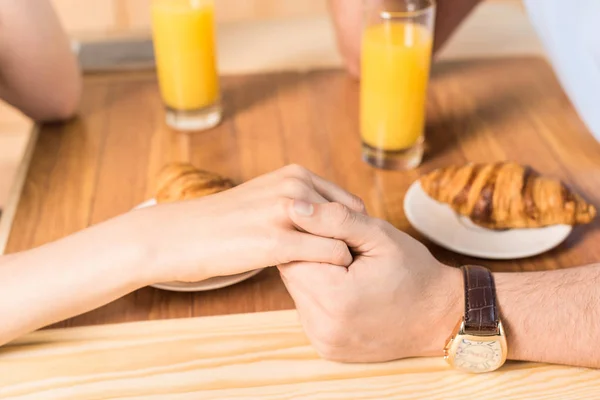 Couple holding hands in cafe — Stock Photo