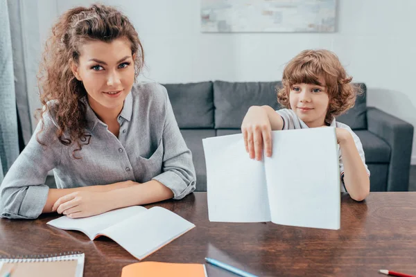 Mother and son doing homework — Stock Photo