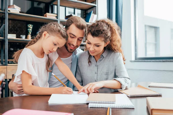 Genitori che fanno i compiti con la figlia — Foto stock