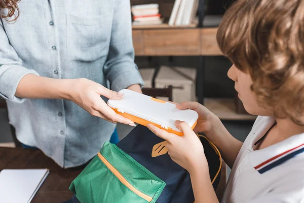 Mother and son preparing backpack for school — Stock Photo