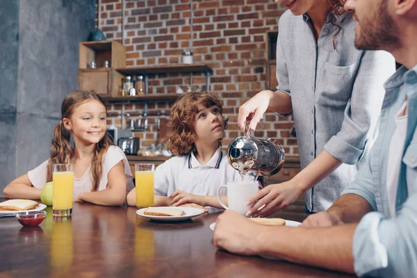 Happy family having breakfast — Stock Photo