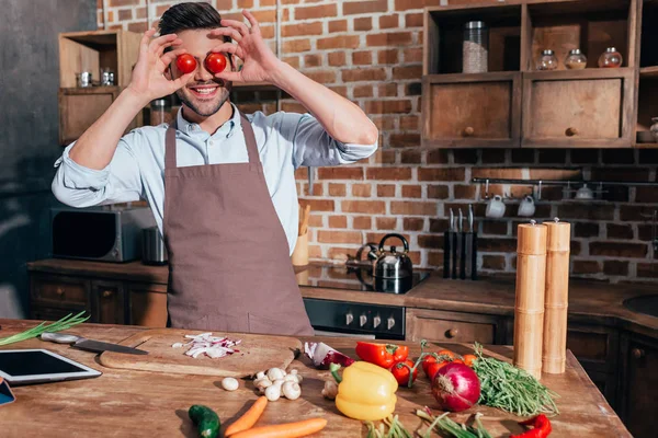 Homem cobrindo olhos com tomates — Fotografia de Stock
