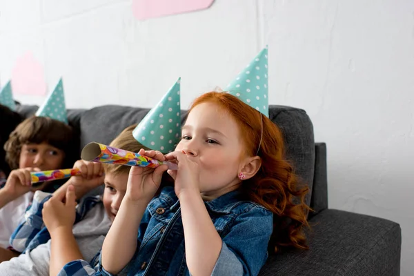 Children with party blowers — Stock Photo