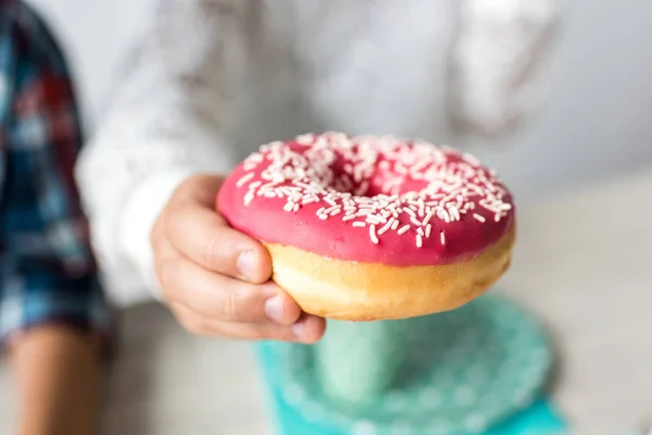 Child holding doughnut — Stock Photo