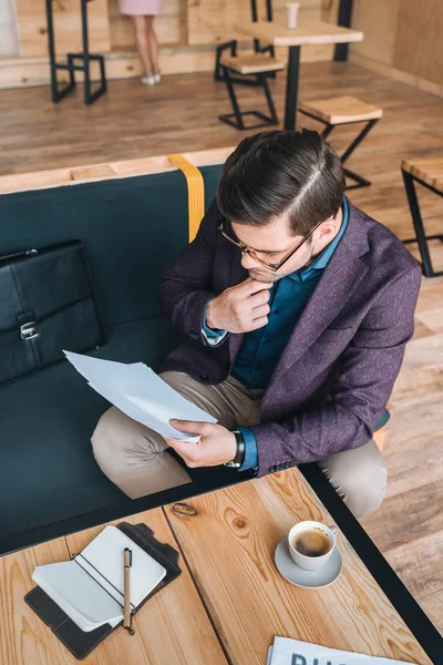 Empresário fazendo papelada no café — Fotografia de Stock