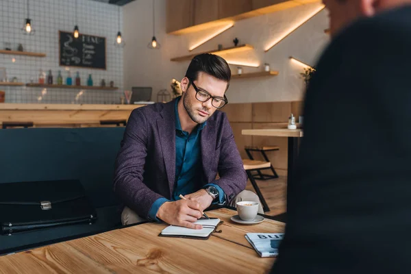Businessmen having meeting in cafe — Stock Photo