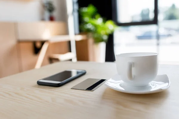 Smartphone, credit card and cup of coffee — Stock Photo