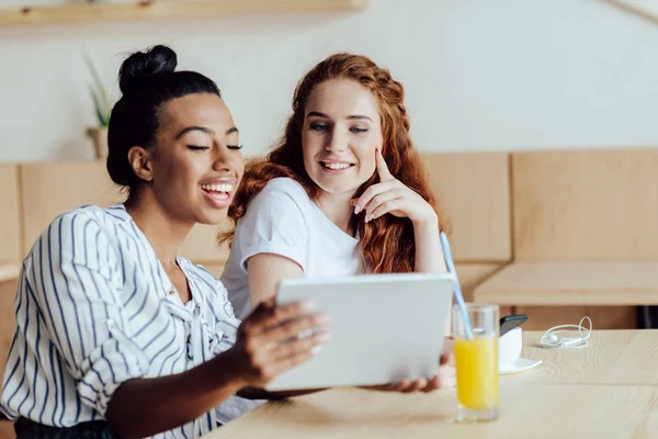 Multiethnic girls with digital tablet — Stock Photo