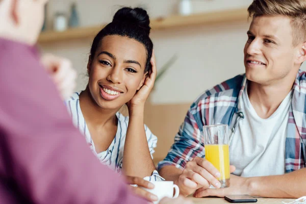 Multiethnic friends drinking beverages — Stock Photo