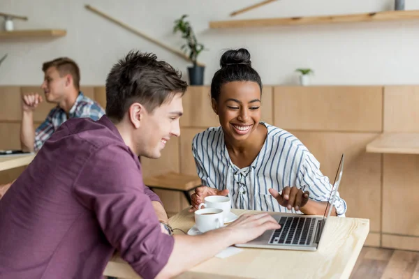 Multiethnic couple using laptop — Stock Photo