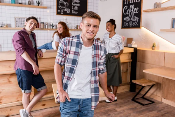 Cheerful boy with friends in cafe — Stock Photo