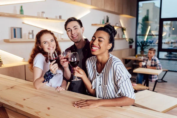 Multiethnic friends drinking wine — Stock Photo