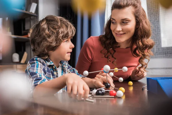 Family playing with atoms model — Stock Photo
