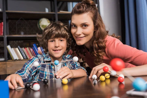 Family playing with atoms model — Stock Photo