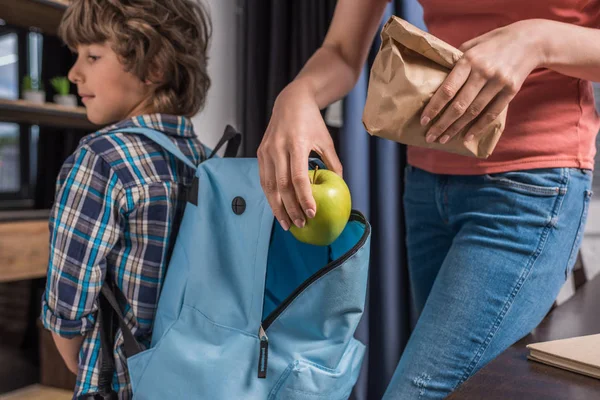 Mother packing son before school — Stock Photo