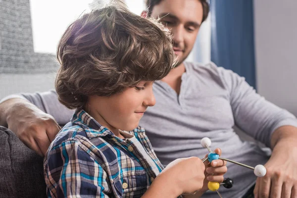 Kid building atoms model — Stock Photo