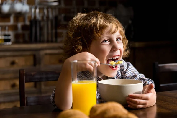 Child eating breakfast — Stock Photo