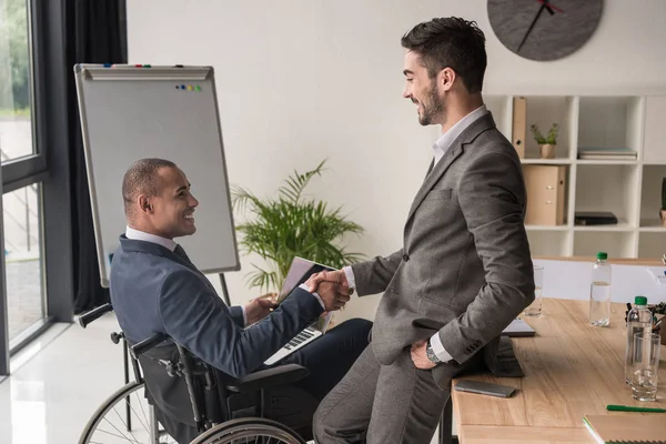 Empresarios multiétnicos dándose la mano - foto de stock