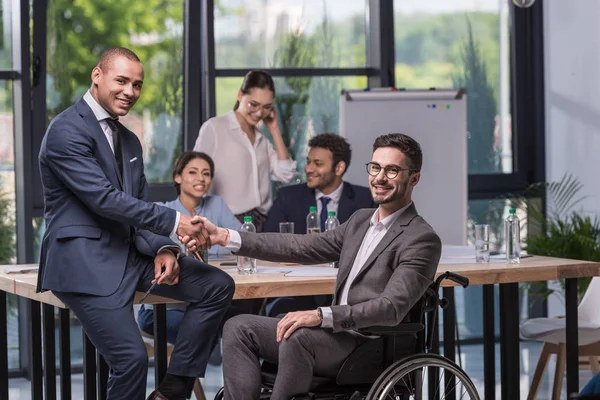 Multicultural businesspeople shaking hands — Stock Photo